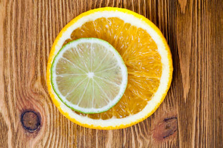 cut slices of orange and lime, lying next to each other and photographed close-up. Small depth of fieldの写真素材