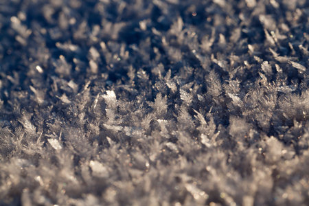 yellow snowdrifts, on which crystals and snowflakes are visible. Small depth of field. sunset