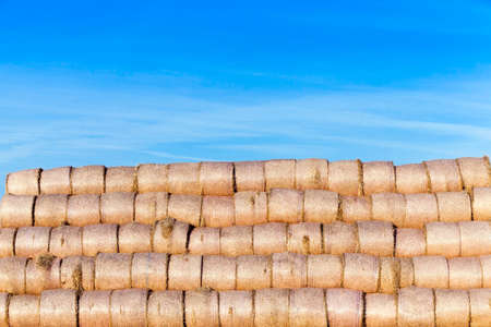 haystacks piled straw after harvest in the agricultural field. Photo in the autumn seasonの写真素材