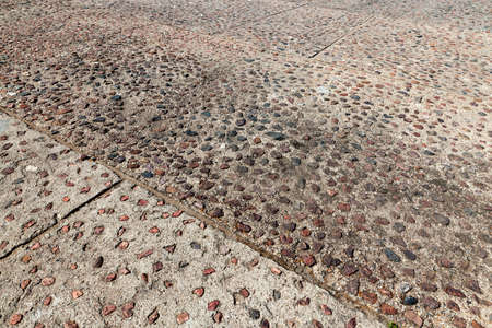 photographed part of an old floor covering made of stones and cobblestones. Photo close upの写真素材