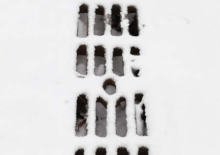 Grate under the snowの写真素材