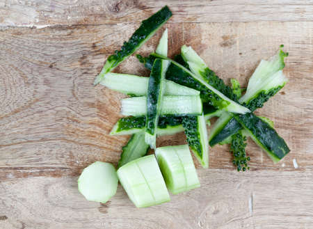 peeled and chopped ripe cucumber on a cutting board, close-upの写真素材