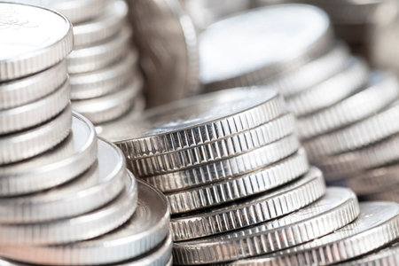 ribbed side of silver coins stacked in heaps, closeup