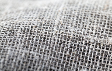 rough gray linen material lying on the table, closeup photo, small depth of field