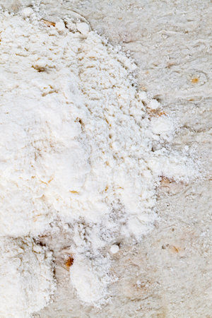 a pile of white wheat flour lying on a thin wheat pita bread, close-up, top viewの写真素材