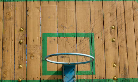 old wooden shield and a metal ring for playing basketball near the city, closeup of a game with a ball in the countrysideの写真素材