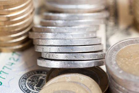 old dirty and defective euro coins on cash banknotes, closeupの写真素材