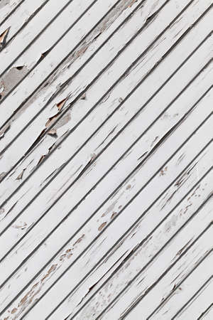 lined and reinforced with wooden slats painted gray wall of a building made of wood, close-up, the painted surface is not ideal and will coverの写真素材