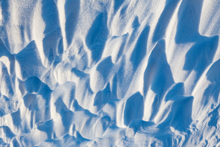 uneven wavy snow drifts after snowfall and strong wind , Surface photographed on the side with a...