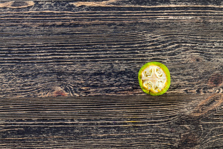 broken and cut green walnut with unformed fruit, summer
