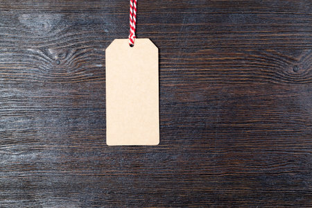 A paper tag made of recycled paper with a red white rope, used for advertising, price tags and other...