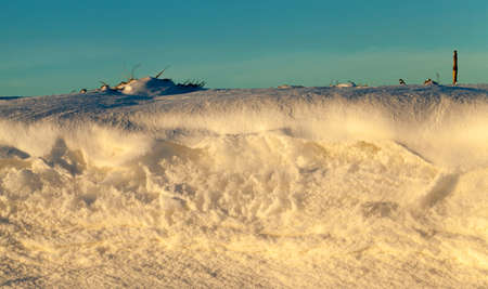 Side of a high snowdrift in sunny weather at sunset, closeupの写真素材