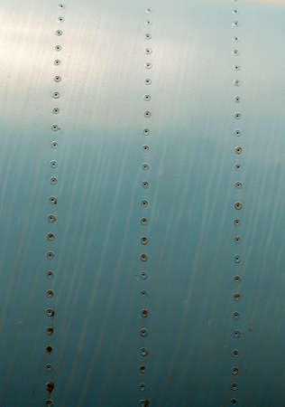 old green metal construction connected by aluminum rivets, used in aircraft building, disused mechanismsの写真素材