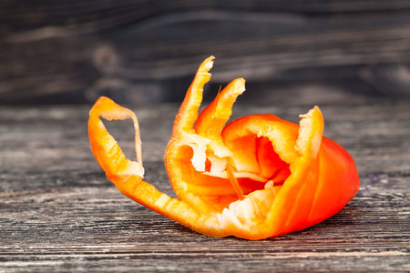 cut ripe red pepper on a salad, close-up of a summer salad preparation