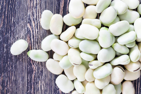 collected harvest of a green bean, lies on a wooden table