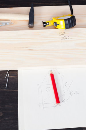 board, drawing on paper from a birdhouse and building tools for its production