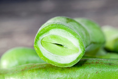 washed and cut bean pods with beans during cooking