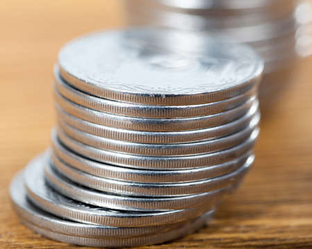 steel metal coins lying in a pile, closeup of cashの写真素材