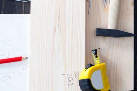board, drawing on paper from a birdhouse and building tools for its productionの写真素材