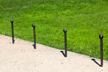 primitive metal stops for traffic with black wooden knobsの写真素材