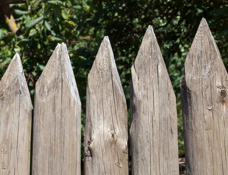 made of small boards and logs of a part of the sharp stockade on the territory of the building, a...