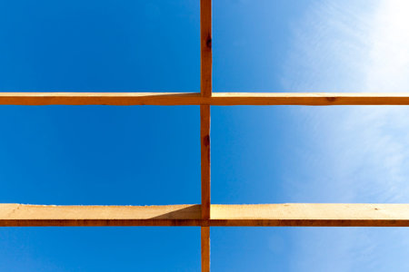 construction of a new frame house, where the frame of wooden boards is assembled, close-up from the...