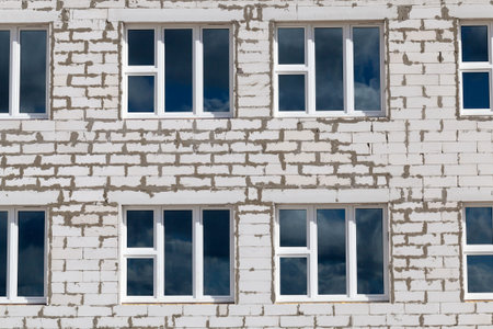 new windows in a brick building under construction in the city, closeup