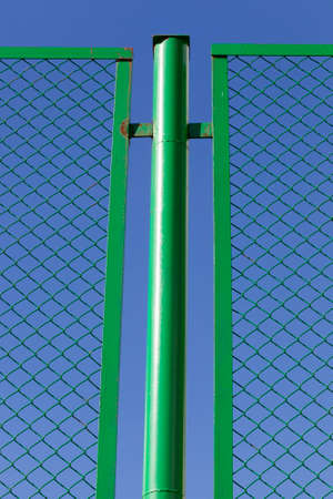 metal grill against the blue sky, fenced territoryの写真素材