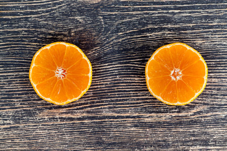 delicious tangerines, peeled orange peel lying on a wooden table, healthy citrus fruits with lots of...