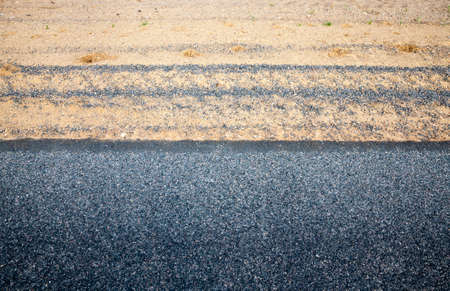 The edge of the asphalt road with the side of the road in asphalt, The side of the sand , top viewの写真素材