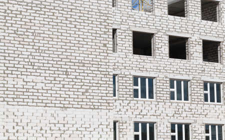 construction of a new multi-storey building of white gas silicate bricks, a multi-storey structure with residential apartments at the beginning of constructionの写真素材