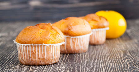 Cupcake's with yellow lemon frosting swirl sugar butter icing lots in a rowの写真素材