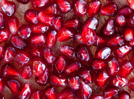 Grains of red ripe pomegranate, juicy and tasty in the open fruit