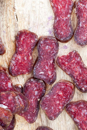 Home-made sausage made from red meat lying in the kitchen during the preparation of a large number of snacks for the holiday.の写真素材