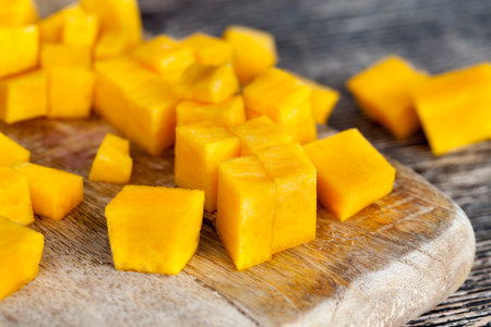 Piled together diced orange pumpkin slices for making breakfast, food from vegetables, vegetarian foodの写真素材