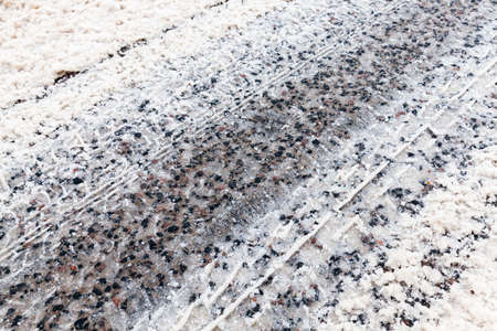 snow-covered road in the winter season. Close-up photoの写真素材