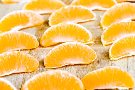 peeled from the bitter rind tasty sweet juicy tangerines of orange color, close-upの写真素材