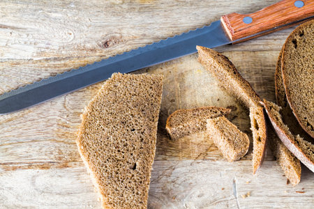 special knife sliced a loaf of bread, a loaf was baked from rye flour is a real , with the flesh cut...