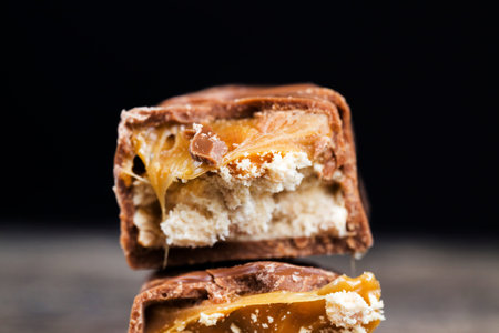 broken milk chocolate with current nougat, close-up of food on the table