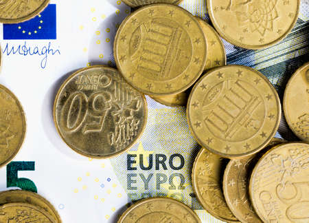 five Euro, close-up photo of a part of a European five Euro banknote with European Union coins, real moneyの写真素材