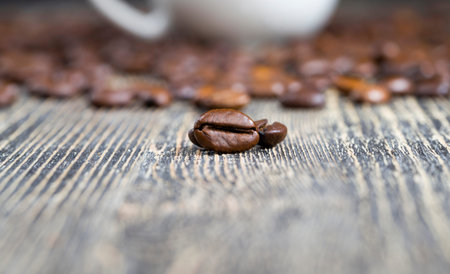 brown freshly roasted aromatic beans of real coffee on the table, close-up of the coffee crop for...