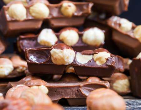 Milk chocolate photographed close-up with roasted hazelnut kernels insideの写真素材