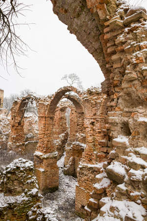 the old brick wall of the building made of red brick, part of the wall is subject to destruction, dilapidated brick archesの写真素材