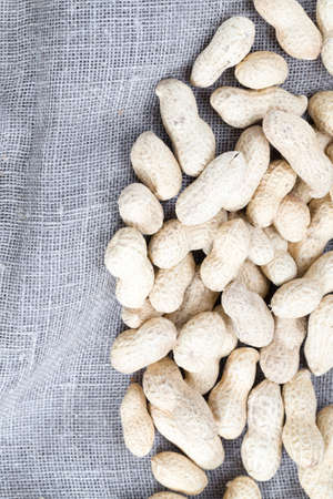 a large number of not peeled peanut nuts during cooking, close-up of the plant is used in people's foodの写真素材