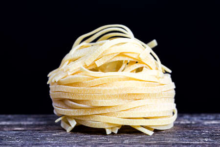 pasta in raw dried form, real noodles and pasta, closeup in the kitchenの写真素材