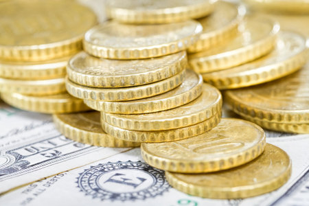 a large number of stacked tower of European coins in fifty Euro cents and less, yellow gold coins on...