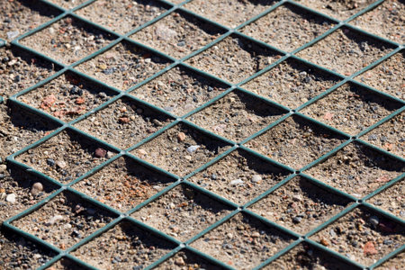 plastic geonet reinforcement on the soil to hold the ground at the construction site, close-up and...