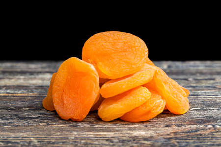 beautiful orange color small dry apricots traditional food in Eastern countries, close-up of dried fruits beautiful color due to the use of chemical additivesの写真素材