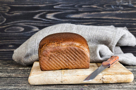 black bitter rye flour bread, close-up of food on kitchen cutting Board