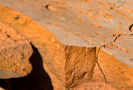 a cracked part of a wall made of brick, a close-up of a part of a poorly made or old structure